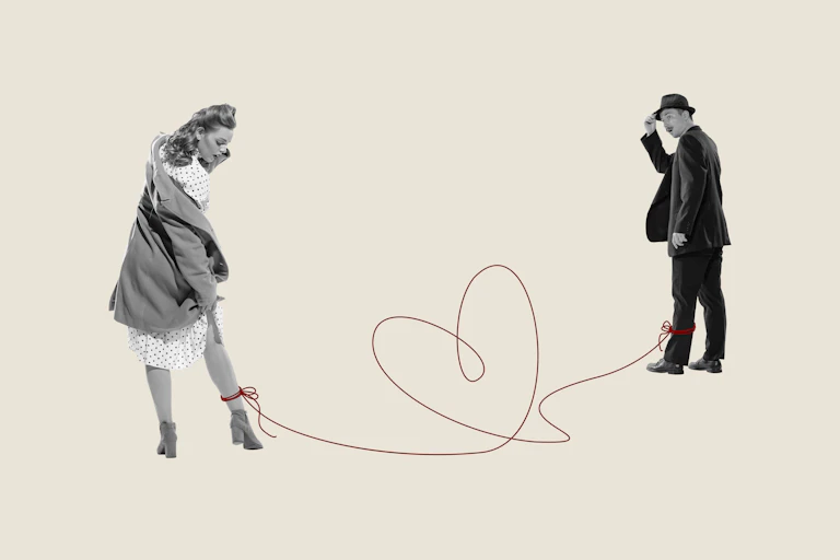 Romantic composition of couple tied around ankles by playful red thread forming heart shape.