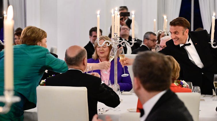 A man and a woman playing champagne flutes.