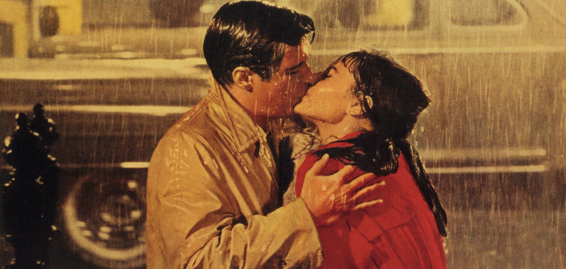 Audrey Hepburn and George Peppard kissing in the rain