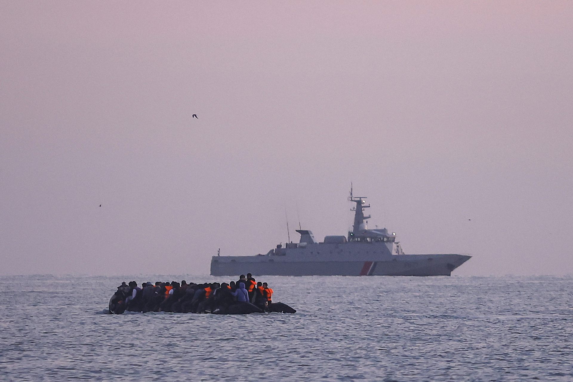 Wide view of a dinghy packed full of people