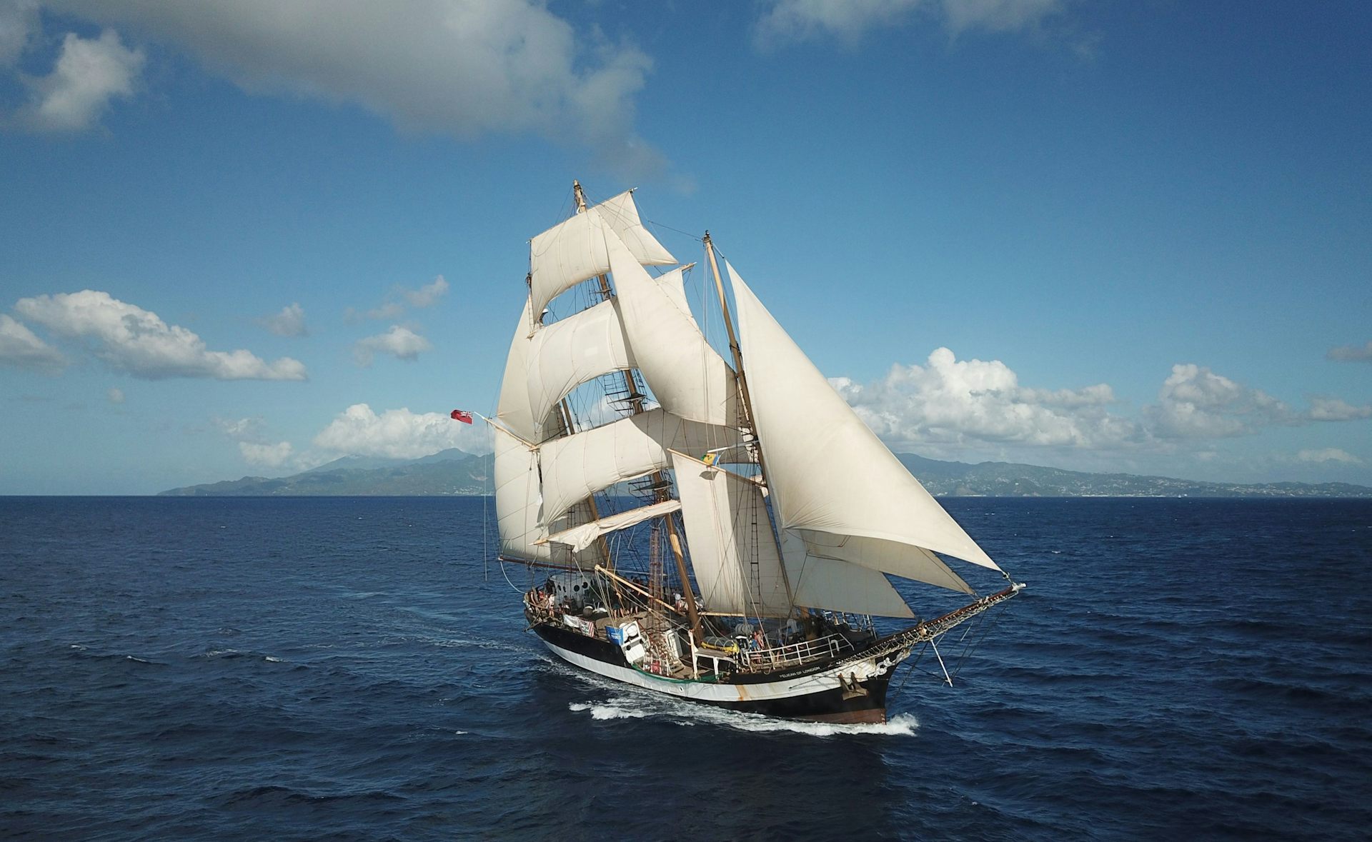 tall ship under sail on blue sea