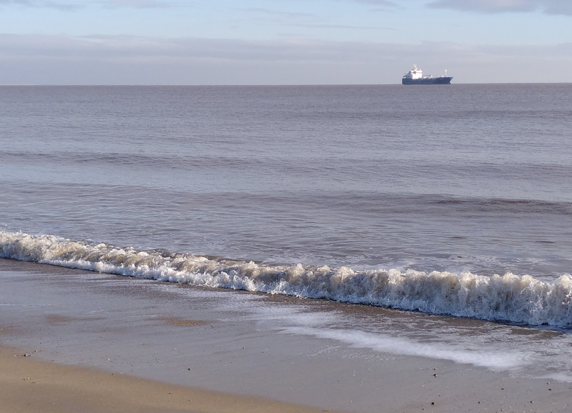 View of the sea with a ship in the distance