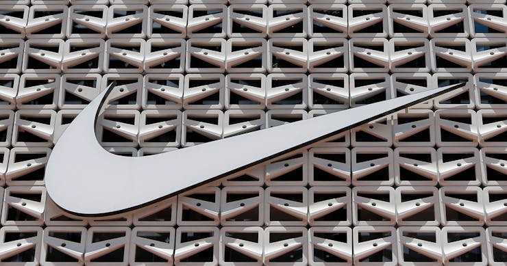 A swoosh logo is seen on a building.