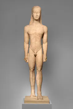 Carving in stone of an idealized nude male figure with one leg ahead of the other