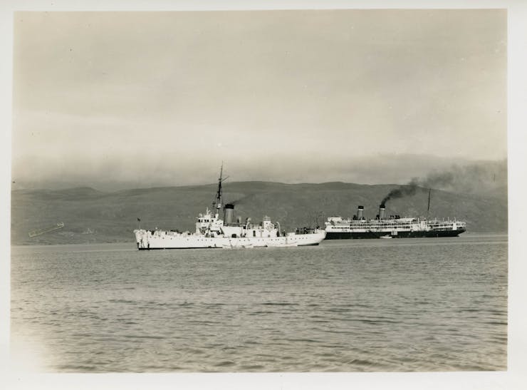 A Coast Guard cutter and Army freighter off Greenland.