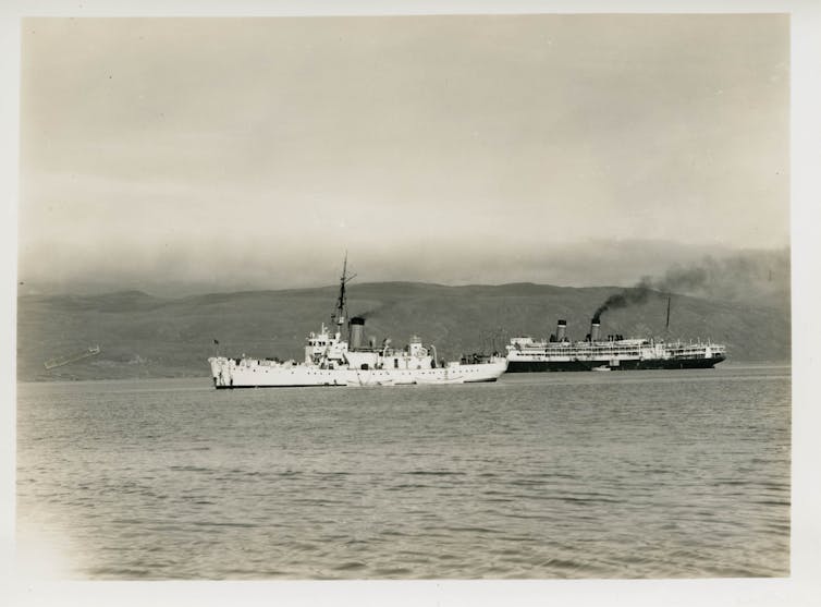 A Coast Guard cutter and Army freighter off Greenland.