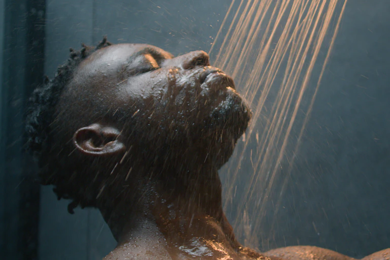 Man having a shower in the dark