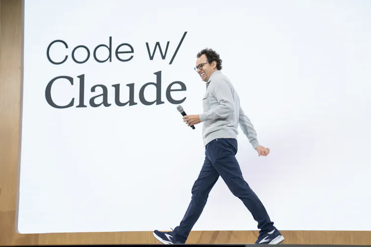 Anthropic chief executive Dario Amodei walks across a stage