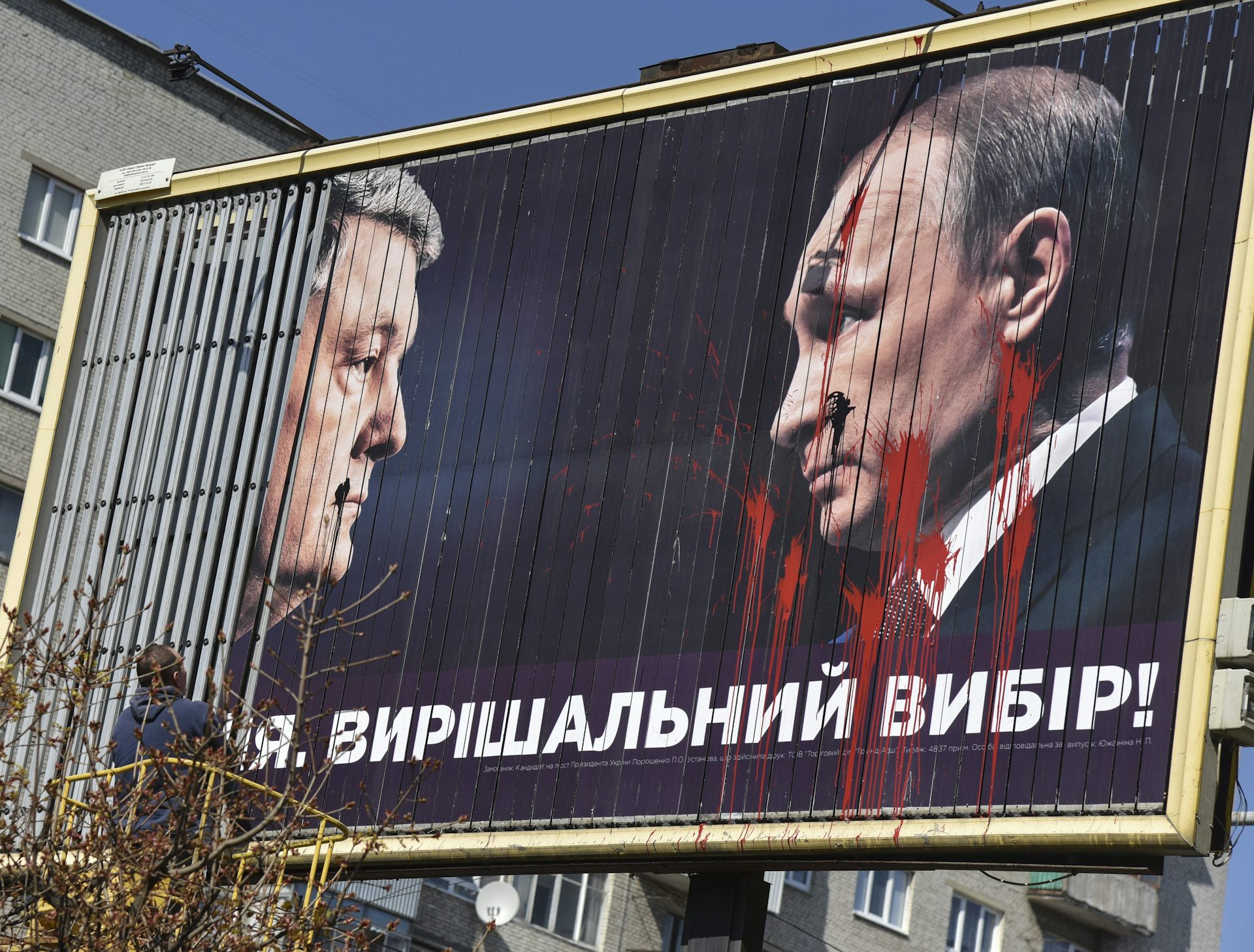 Ukrainian politician Petro Poroshenko faces Vladimir Putin on an election billboard in Ukraine, 2019.