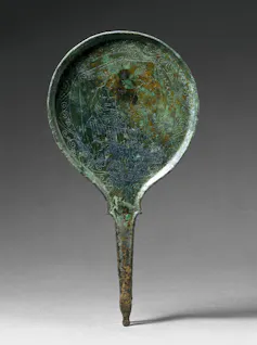 Mirror featuring a couple playing what is believed to be the dice game pentigrami.