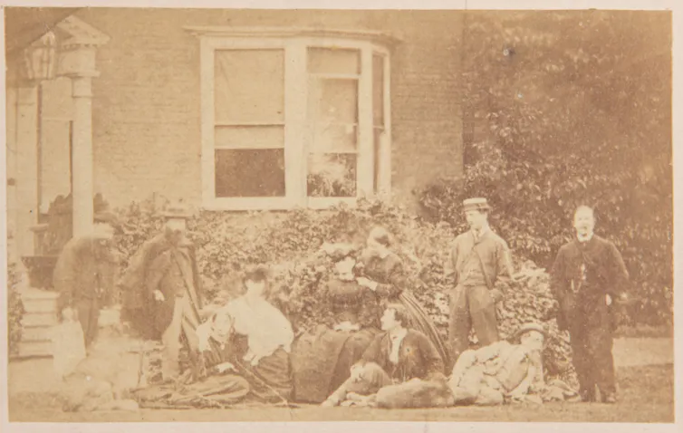 Photograph of Charles Dickens, friends and family outside a house
