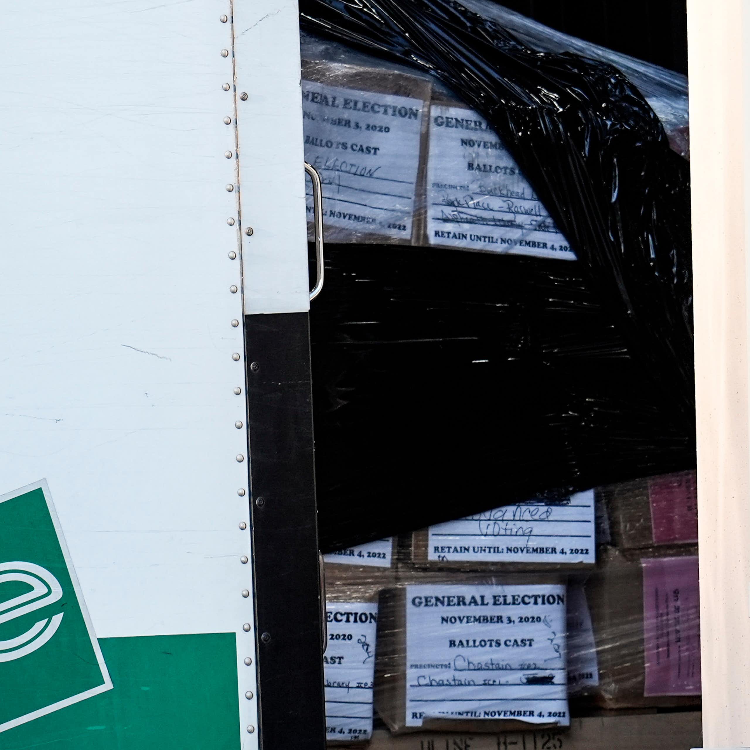 An enterprise trucjk with boxes of ballots in it.