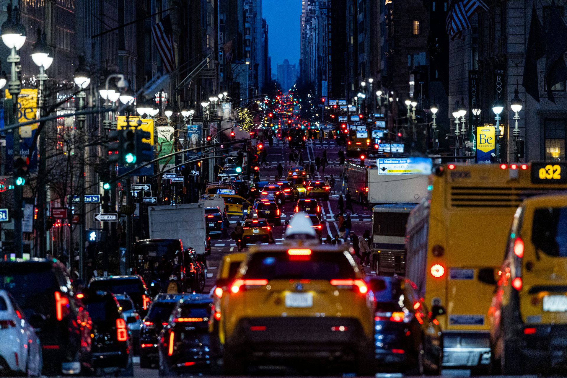 Taxis and other traffic move through midtown Manhattan at dusk in New York.