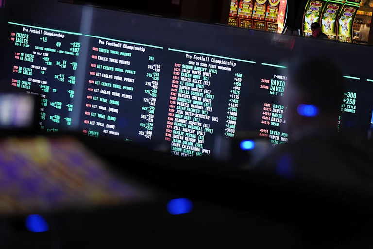 Betting odds for Super Bowl LIX are displayed on monitors