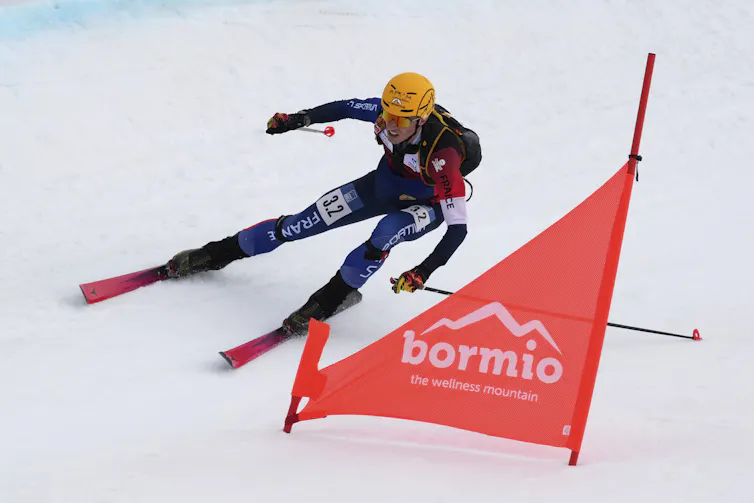 An athlete skiis down a hill