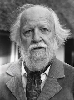 a white-bearded man with a tie and jacket