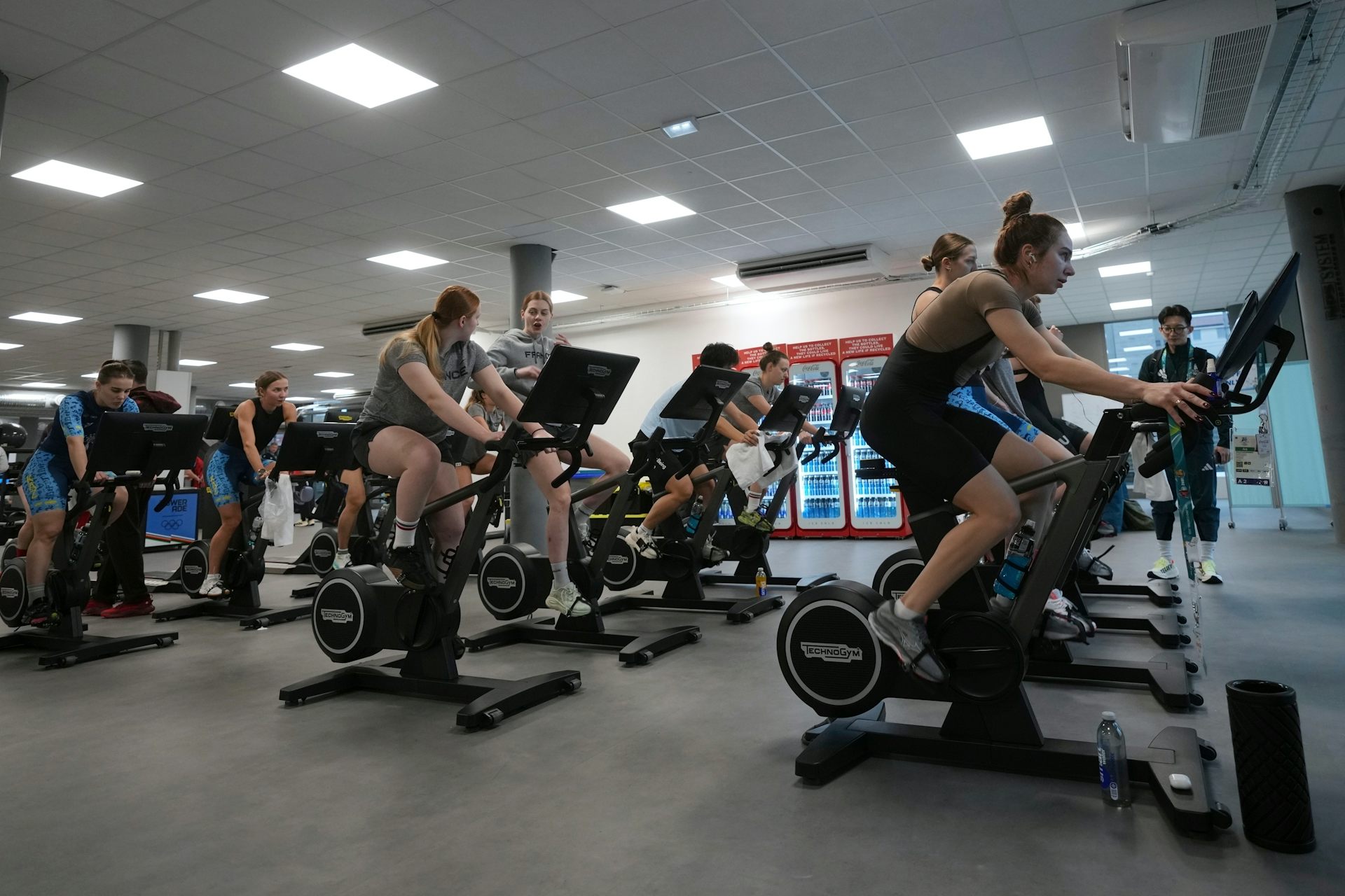 Personas que utilizan equipos de ejercicio en una habitación grande.