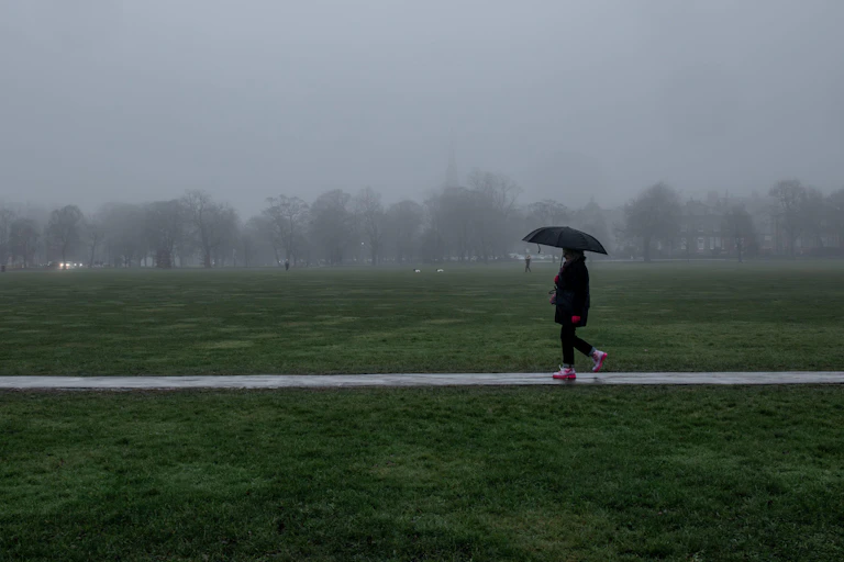 Person with umbrella on miserable day in UK
