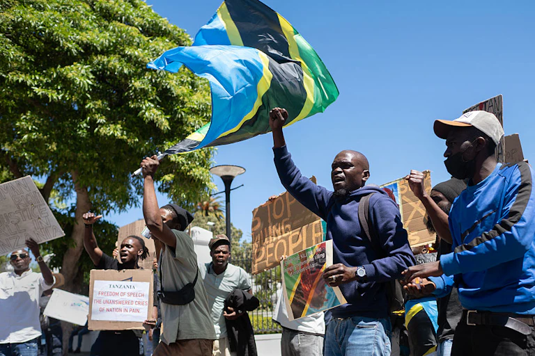 People holding placards and waving a flag