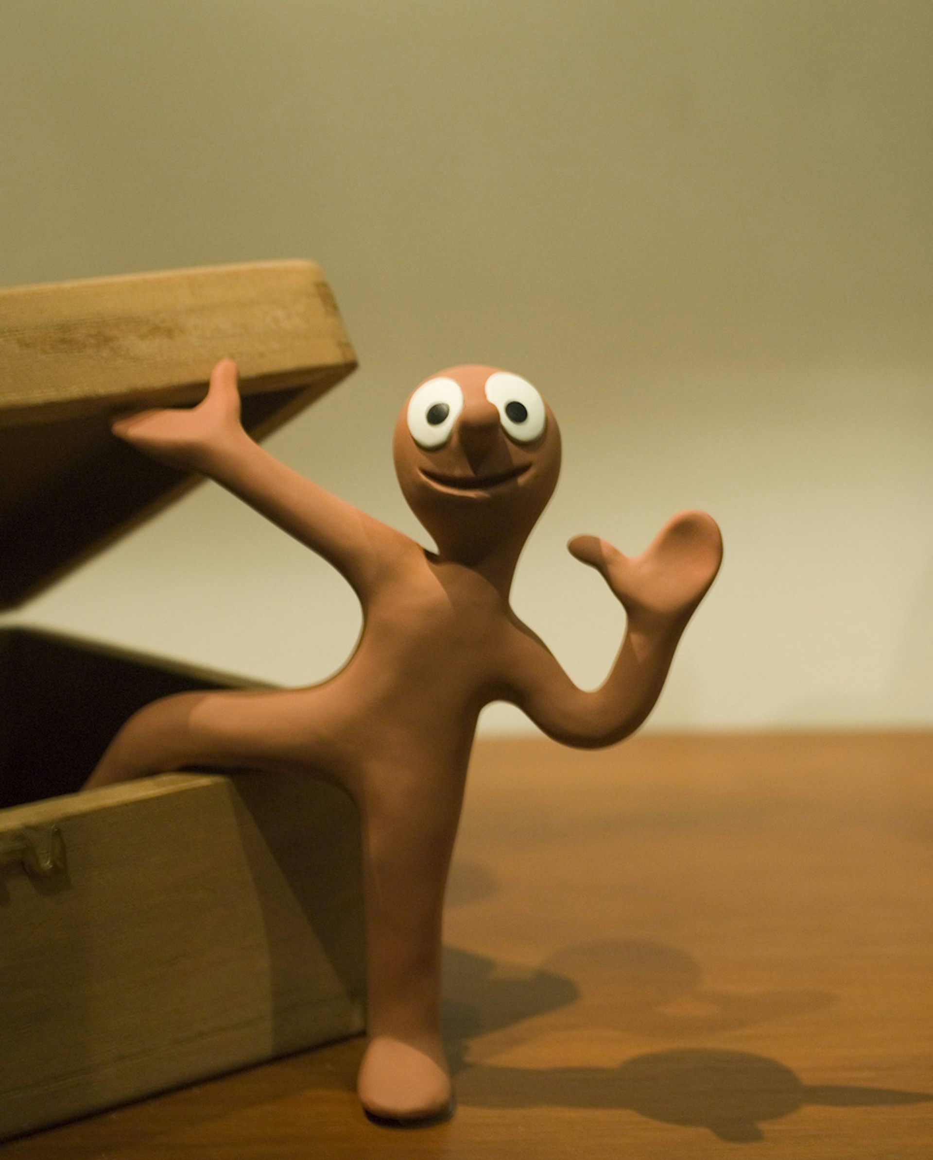An animated character made of Plasticine with big round eyes.