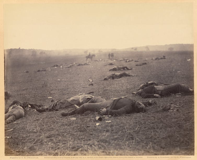 The bodies of dead soldiers strewn across a field.