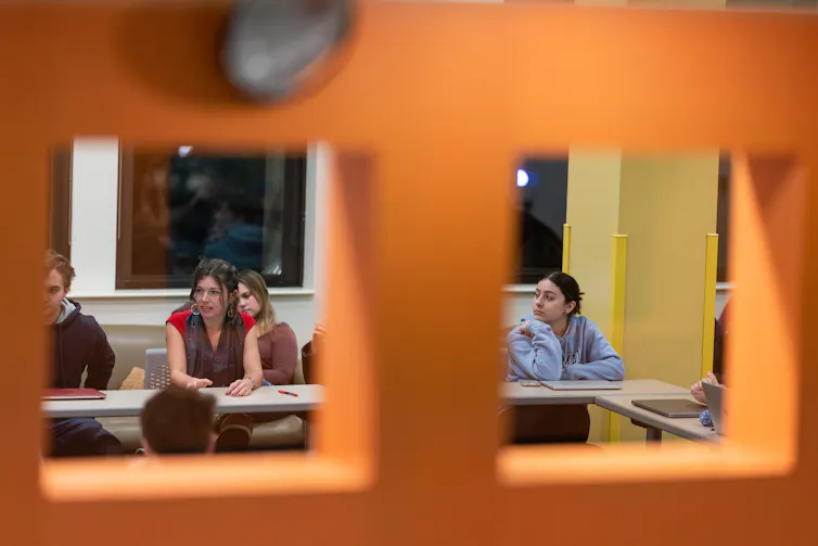 A college student in discussion in a classroom