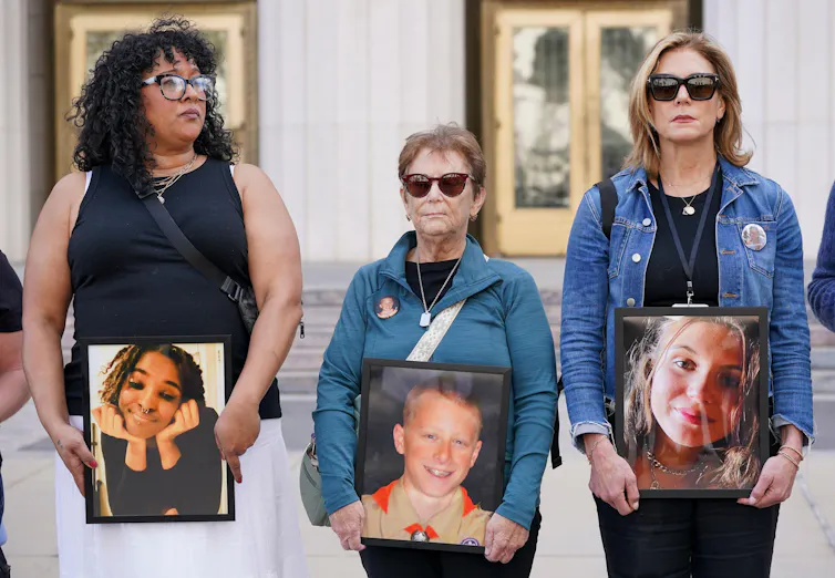 Bereaved parents hold photographs of their lost children outside LA's Superior Court