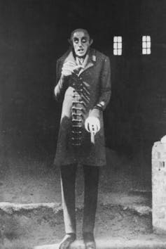 A bald, skinny, elderly vampire with hollow eyes.