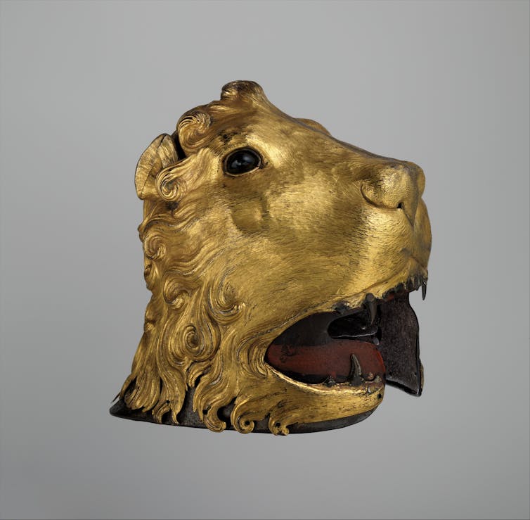 An antique-style helmet fashioned to look like a golden lion's head.