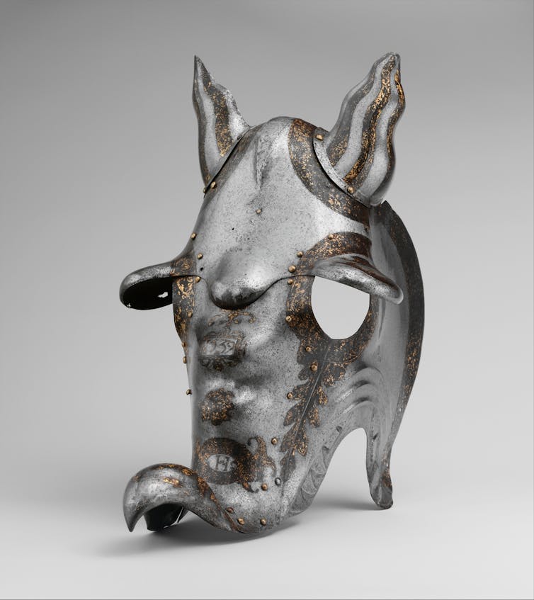A metal horse's helmet fashioned to resemble a dragon's head.