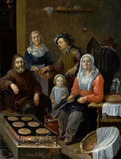 A 1600s painting of a family making pancakes.