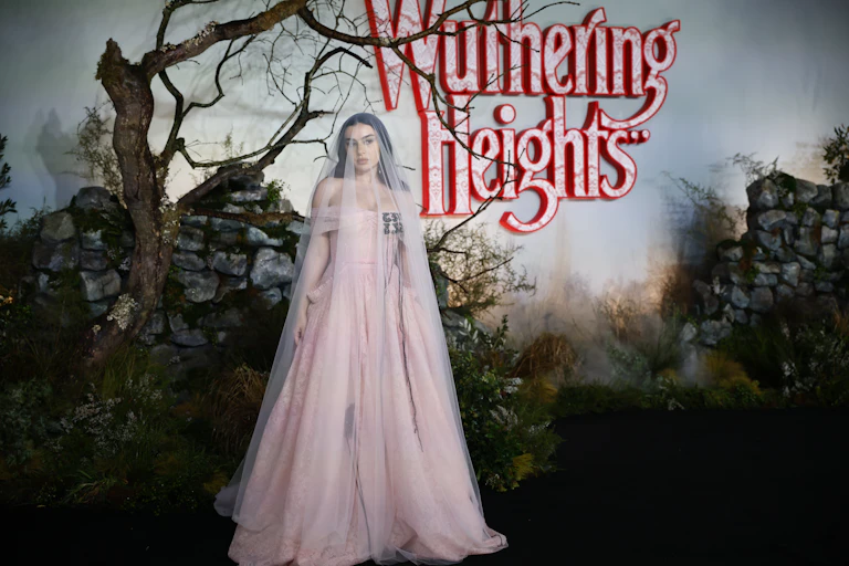 Charli XCX at the Wuthering Heights premiere wearing a pink dress and veil.