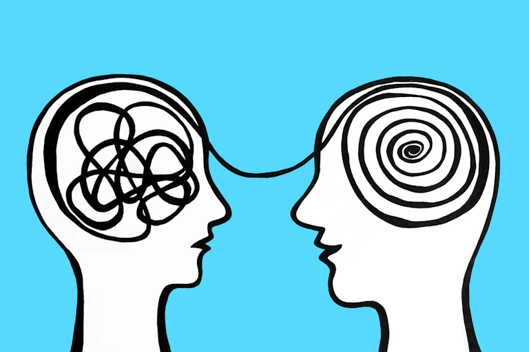 Two cartoon faces with hollow heads, and a spool of thread or yarn running between them.