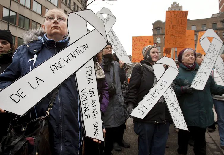 Women holding up white ribbons during a demonstration