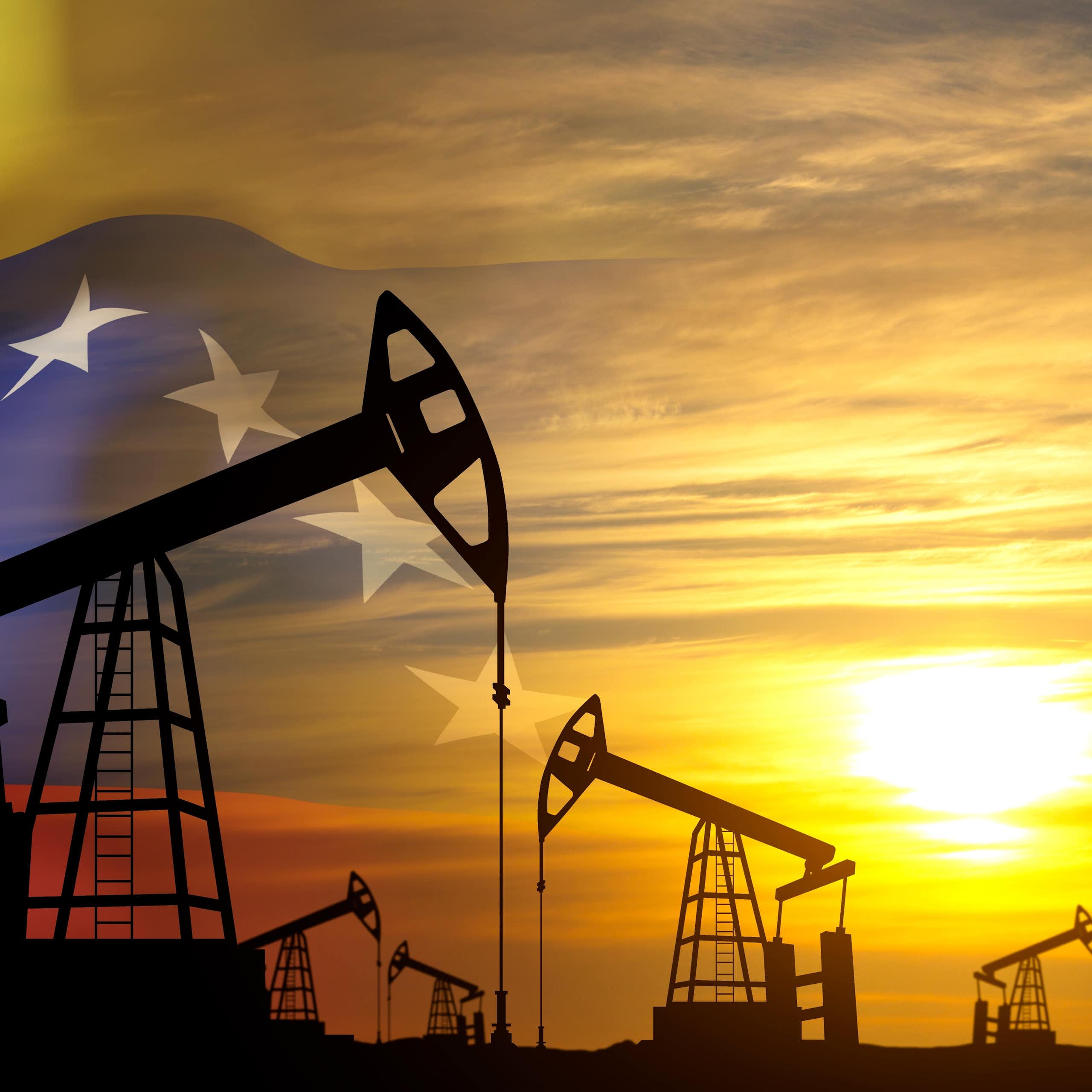 Oil pimps in silhouette against sunset merged with Venezuelan flag.