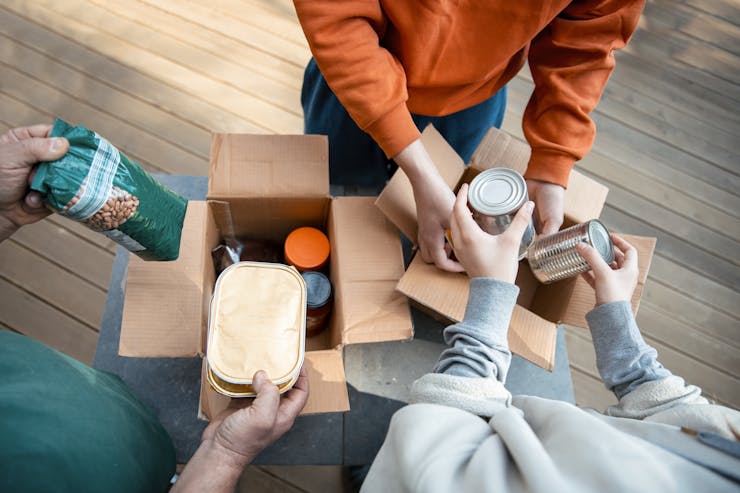 People packing food in donation boxes