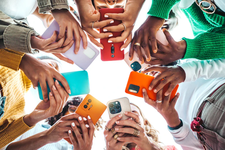 Hands holding smartphones shot from below