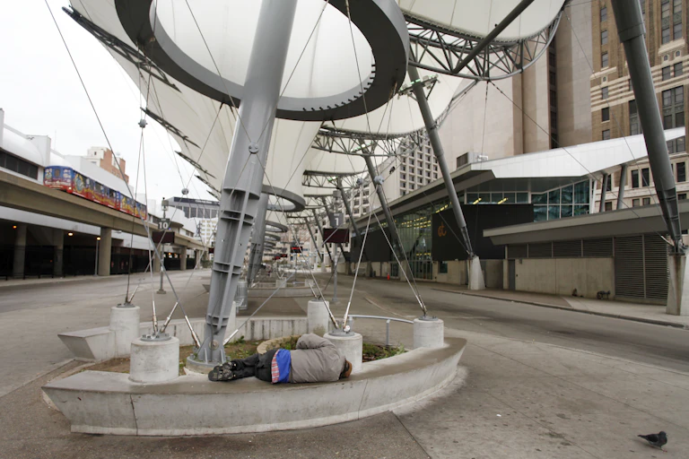 A man sleeps at a bus station in Detroit.