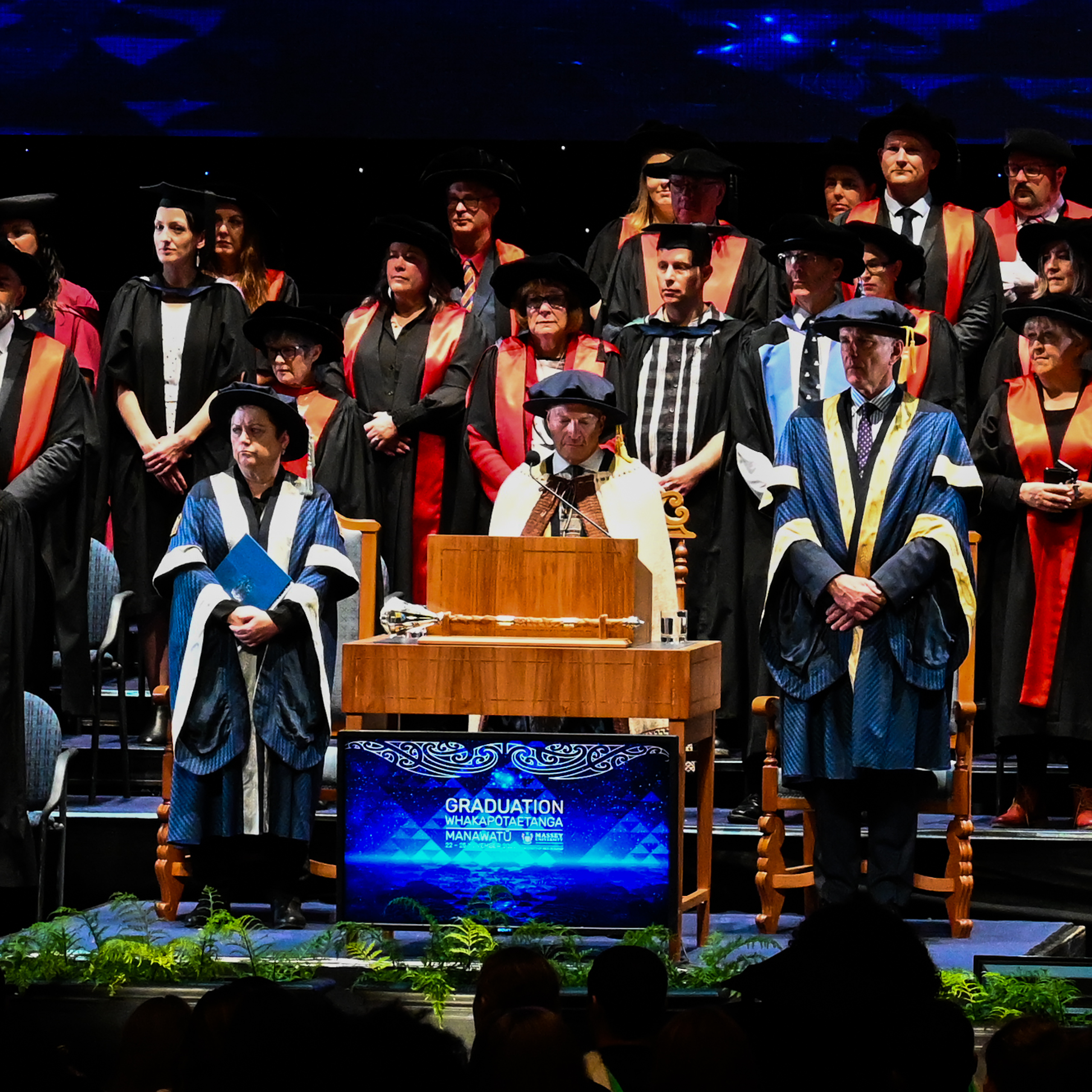 A group of academics wearing gowns during a graduation ceremony