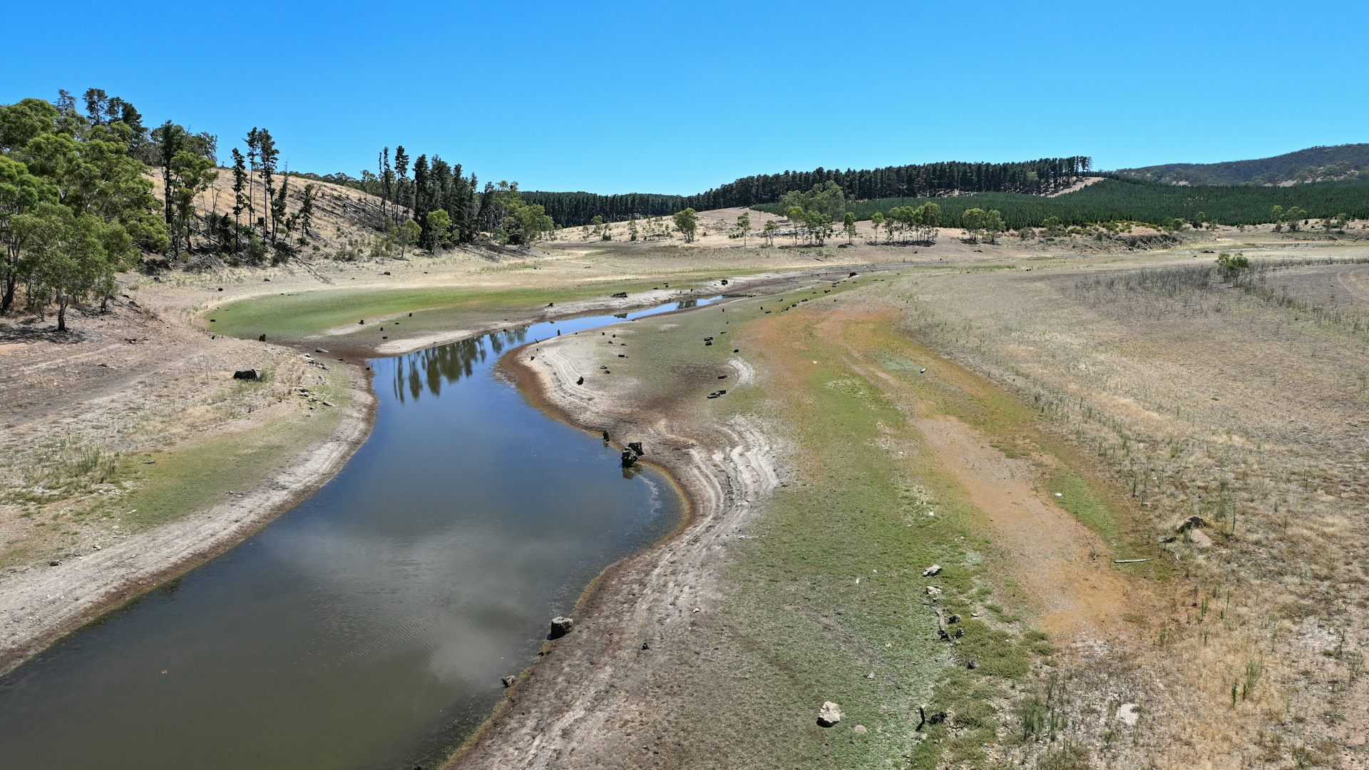 A empty-looking reservoir, with low water levels.