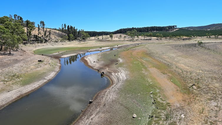 A empty-looking reservoir, with low water levels.