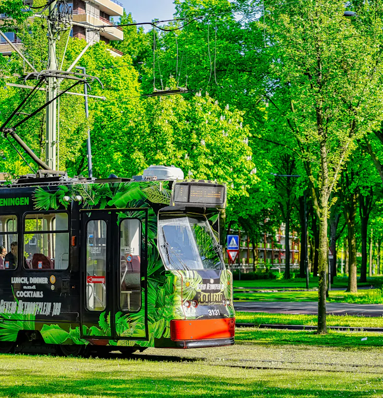 a tram running along green tram tracks