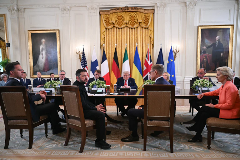 Donald Trump in a room with European leaders and Volodymyr Zelensky.