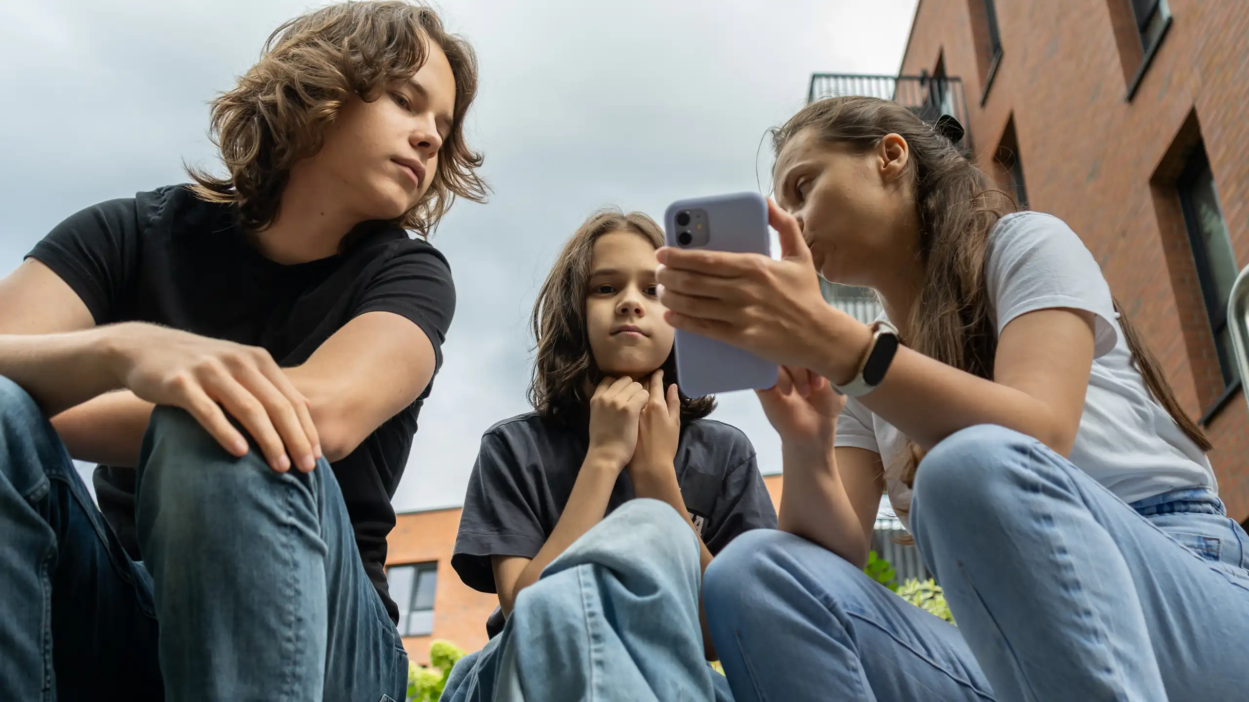 Mother showing phone to sons