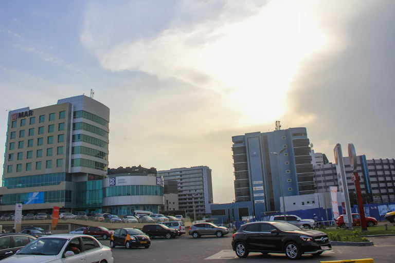 Cars parked among multistorey buildings