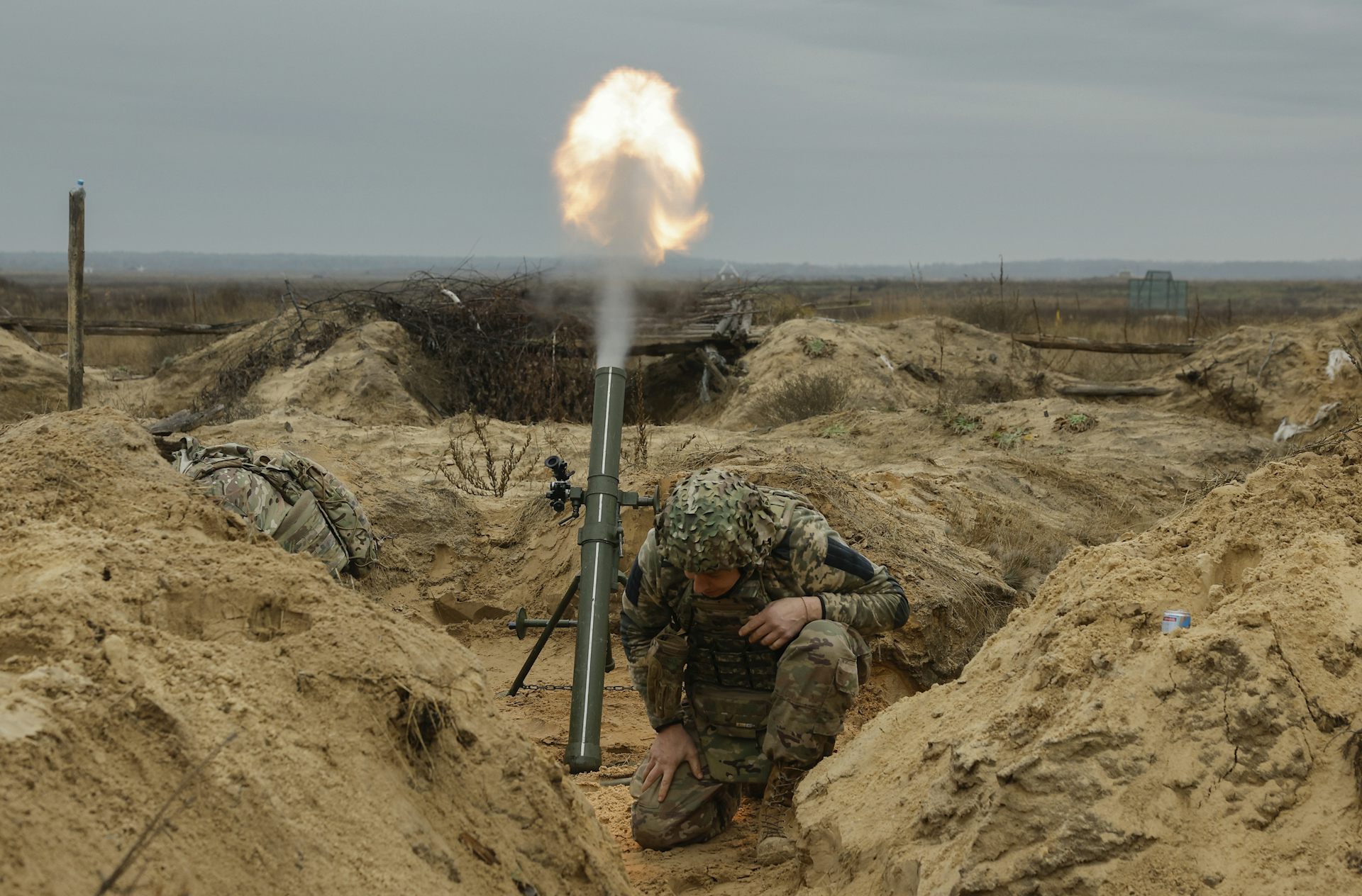 A Ukrainian servicemen fires a mortar.