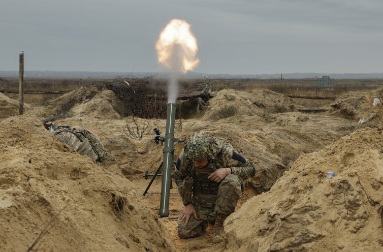 A Ukrainian servicemen fires a mortar.