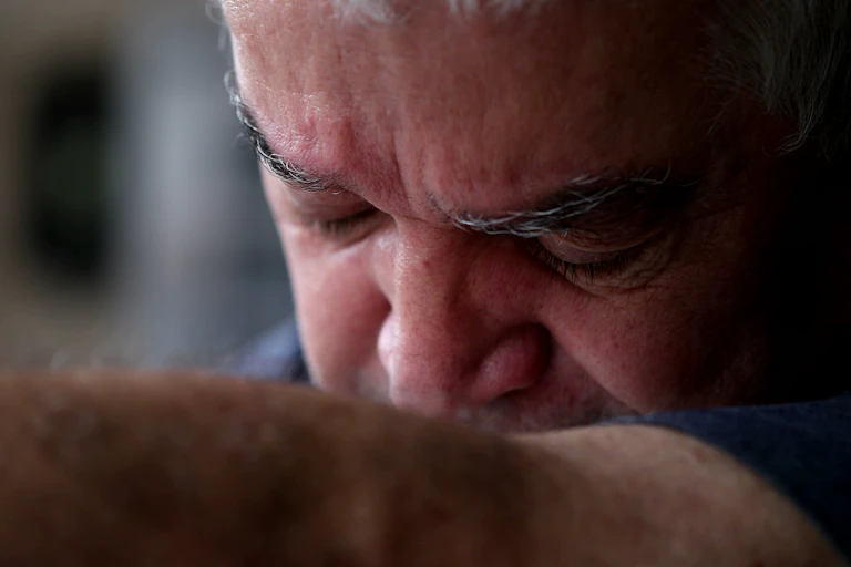 An older man experiencing anguish