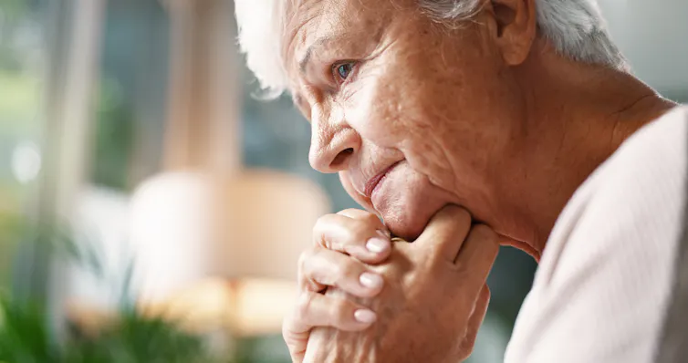 An unhappy senior woman deep in thought.