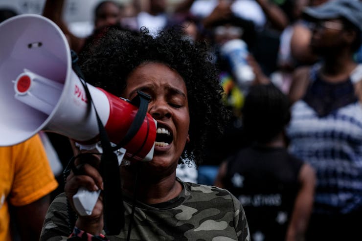 A protester speaks into a megaphone.